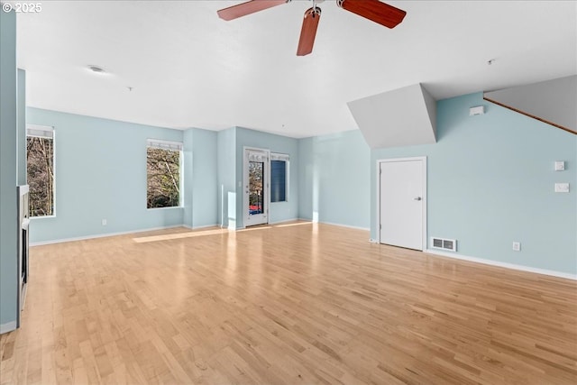 unfurnished living room featuring ceiling fan and light wood-type flooring