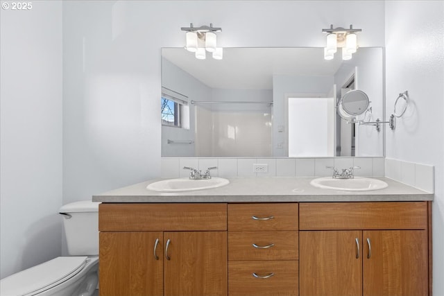 bathroom featuring toilet, walk in shower, and vanity