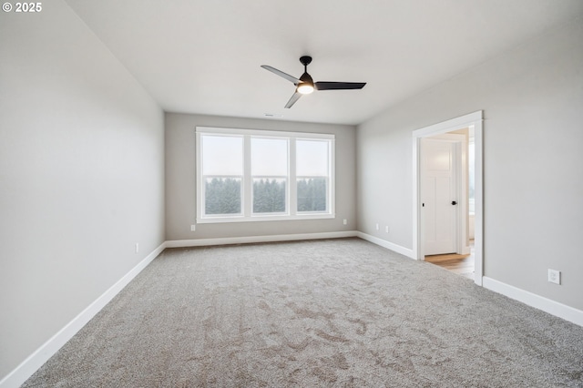 spare room featuring ceiling fan and light carpet