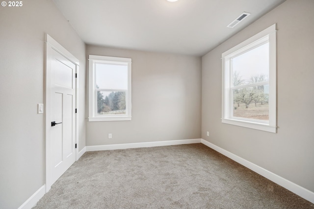 carpeted empty room featuring plenty of natural light