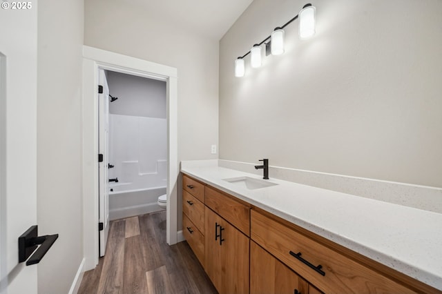 full bathroom with vanity, wood-type flooring,  shower combination, and toilet