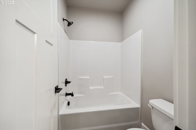 bathroom with tub / shower combination and toilet