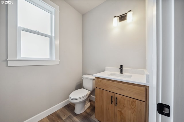 bathroom featuring hardwood / wood-style flooring, vanity, and toilet