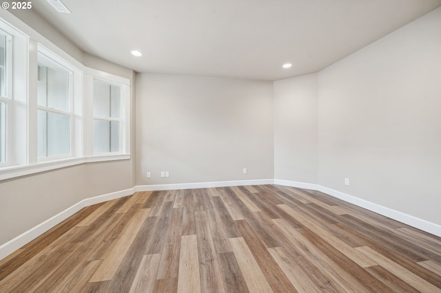 spare room with light hardwood / wood-style floors