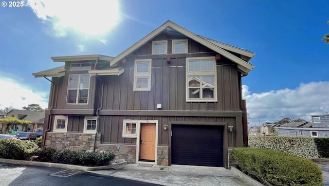 132 E Surfcrest Ave # B2-H, Cannon Beach, OR 97110 - view of front of home with board and batten siding, an attached garage, stone siding, and concrete driveway