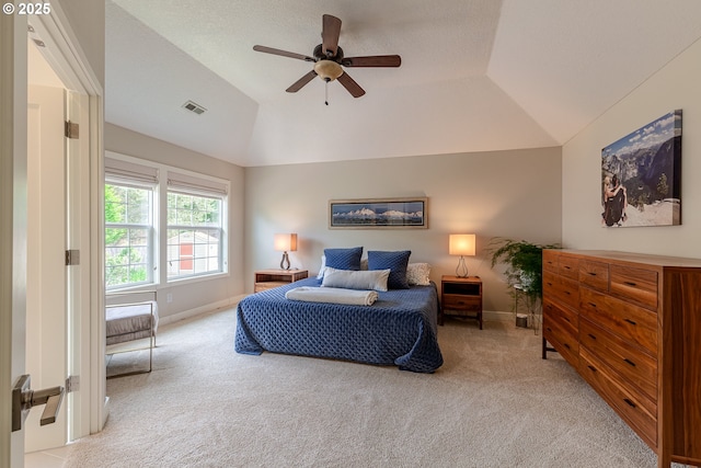 bedroom with vaulted ceiling, carpet flooring, baseboards, and visible vents