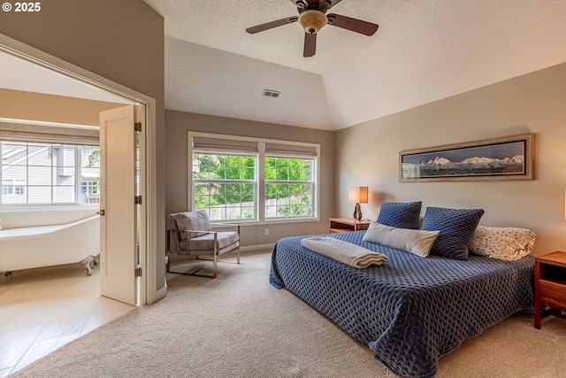 carpeted bedroom featuring visible vents, lofted ceiling, a textured ceiling, and ceiling fan