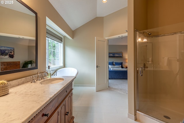 full bathroom featuring vanity, vaulted ceiling, baseboards, and a shower stall