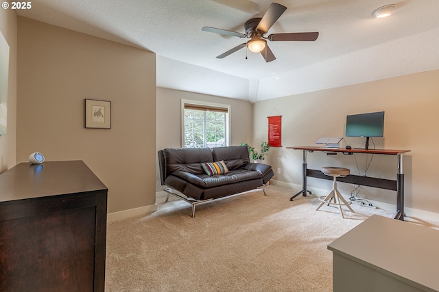 carpeted living room with baseboards, a textured ceiling, ceiling fan, and vaulted ceiling