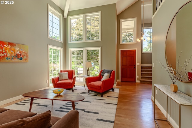 living room featuring stairway, plenty of natural light, baseboards, and light wood-style flooring