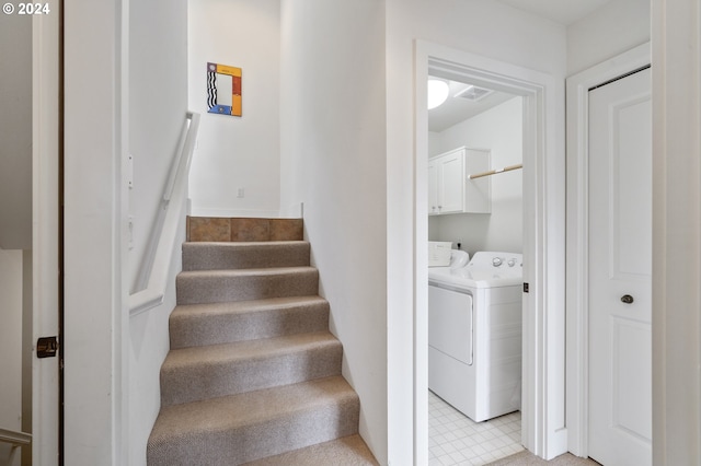 stairway with visible vents, independent washer and dryer, and tile patterned floors