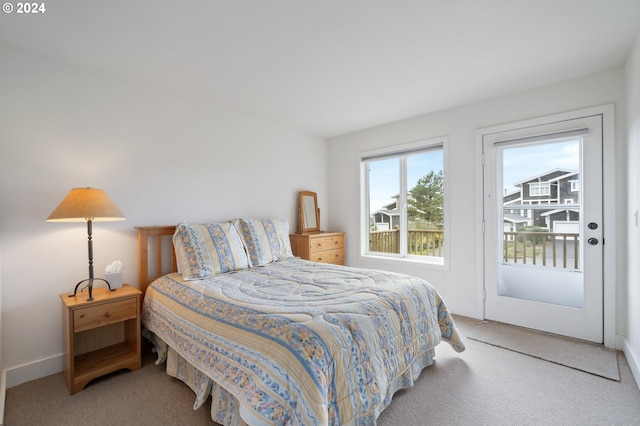 bedroom featuring carpet floors, baseboards, and access to outside