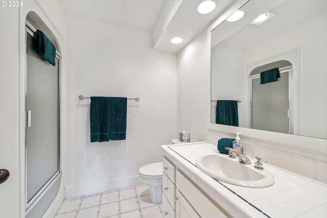 bathroom with vanity, toilet, baseboards, recessed lighting, and tile patterned floors