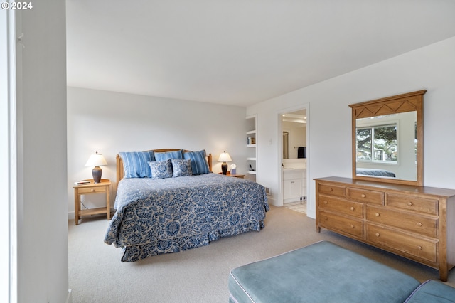 carpeted bedroom with ensuite bathroom