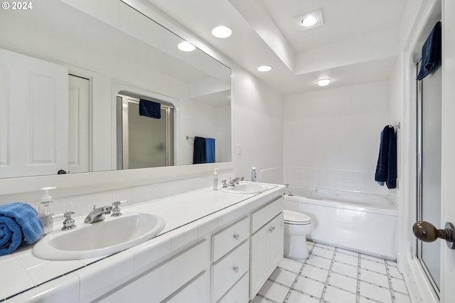 bathroom featuring recessed lighting, a sink, a garden tub, and a stall shower