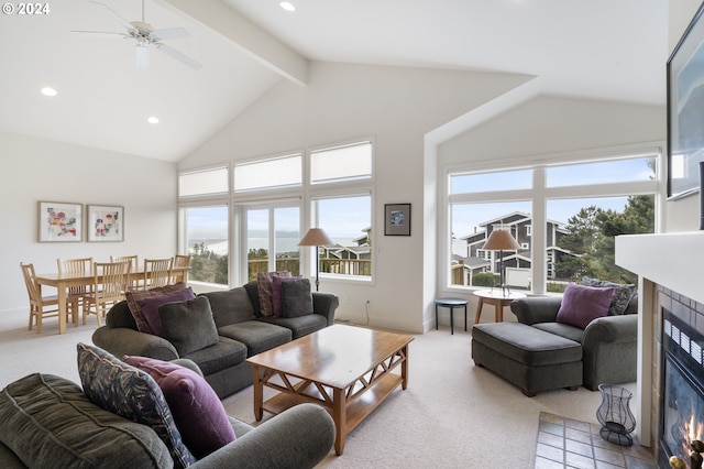 carpeted living area with recessed lighting, beamed ceiling, high vaulted ceiling, and a tile fireplace
