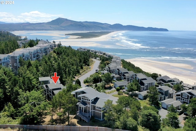 birds eye view of property with a water and mountain view