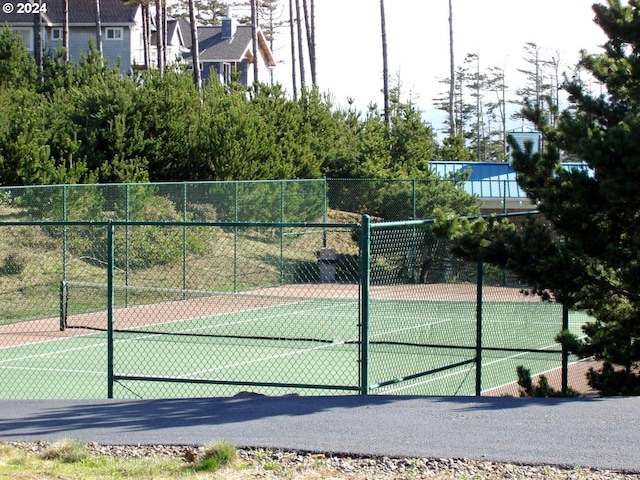 view of sport court featuring fence