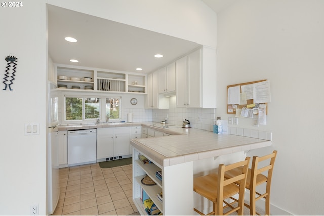kitchen with white cabinets, open shelves, white appliances, a peninsula, and tasteful backsplash
