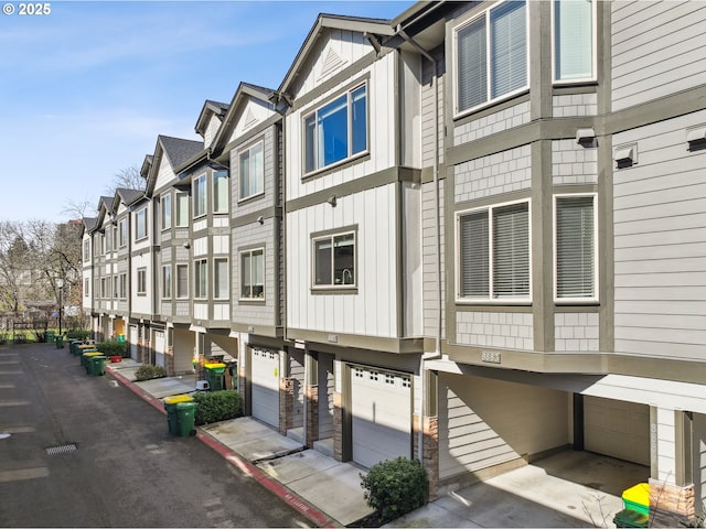 view of building exterior featuring a garage and a residential view