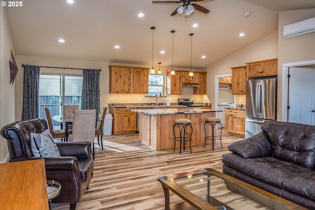 5135 Grange Rd, Roseburg, OR 97471 - living room featuring light wood finished floors, a ceiling fan, a wall mounted air conditioner, lofted ceiling, and recessed lighting
