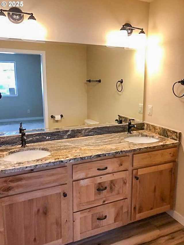 5135 Grange Rd, Roseburg, OR 97471 - full bath with double vanity, wood finished floors, and baseboards