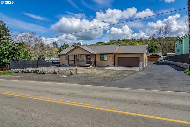 5135 Grange Rd, Roseburg, OR 97471 - ranch-style house featuring an attached garage, metal roof, driveway, and crawl space
