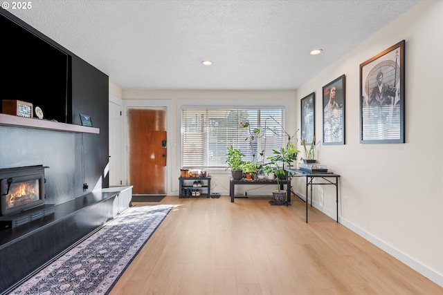 interior space with light hardwood / wood-style floors and a textured ceiling