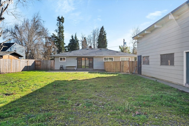 rear view of house with a yard and a patio area