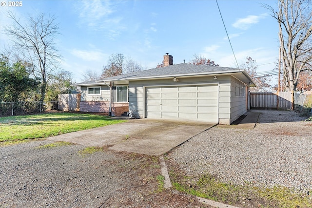 ranch-style home featuring a garage and a front lawn