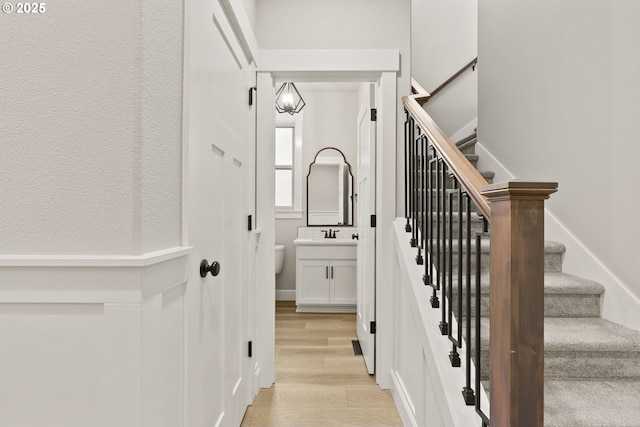 stairway with wood finished floors