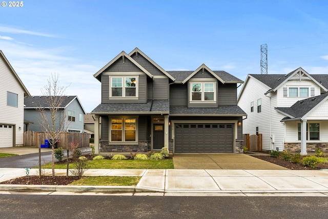 craftsman-style house featuring stone siding, concrete driveway, fence, and an attached garage