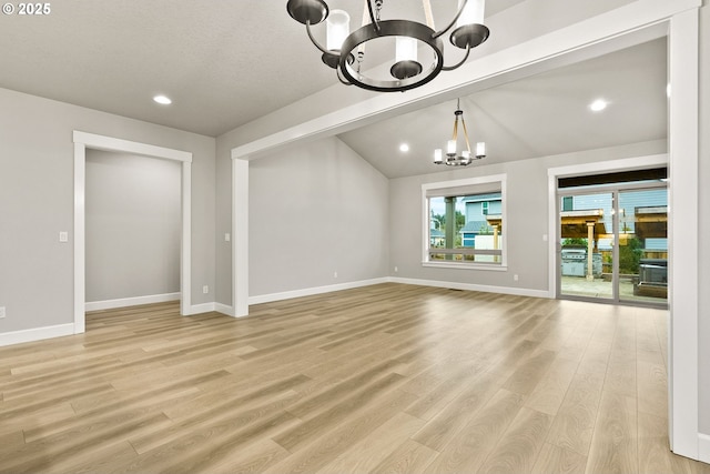 unfurnished living room featuring recessed lighting, light wood-style flooring, an inviting chandelier, vaulted ceiling, and baseboards