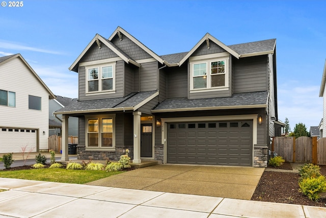 craftsman inspired home featuring a porch, a shingled roof, concrete driveway, a garage, and stone siding