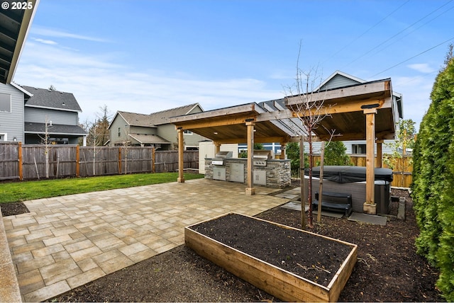 view of patio / terrace featuring a fenced backyard, a hot tub, and area for grilling