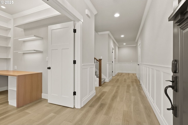 corridor featuring crown molding, recessed lighting, wainscoting, and light wood-style floors