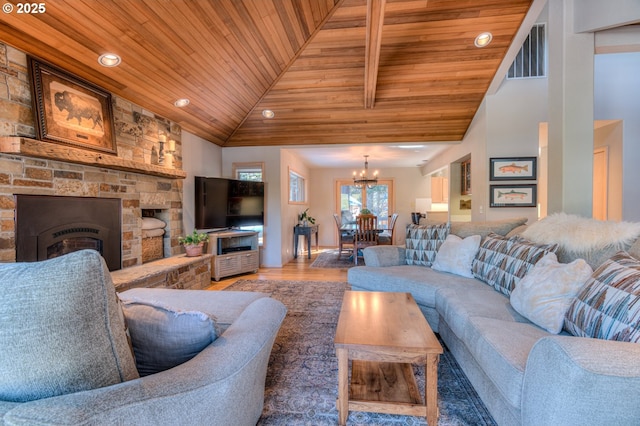 living room with visible vents, a fireplace, wood ceiling, and wood finished floors