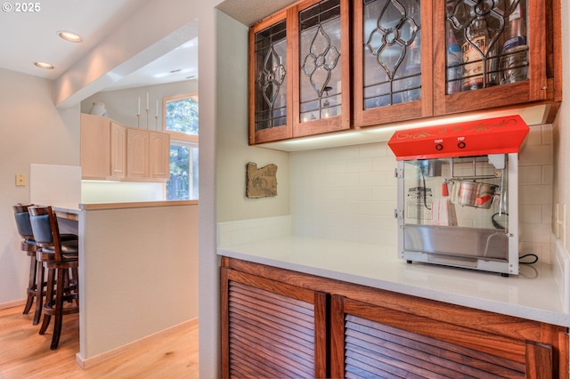 bar with recessed lighting, baseboards, tasteful backsplash, and light wood finished floors