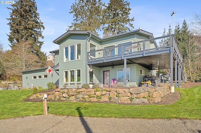9065 8th St, Bay City, OR 97107 - view of front of home featuring a deck and a front yard