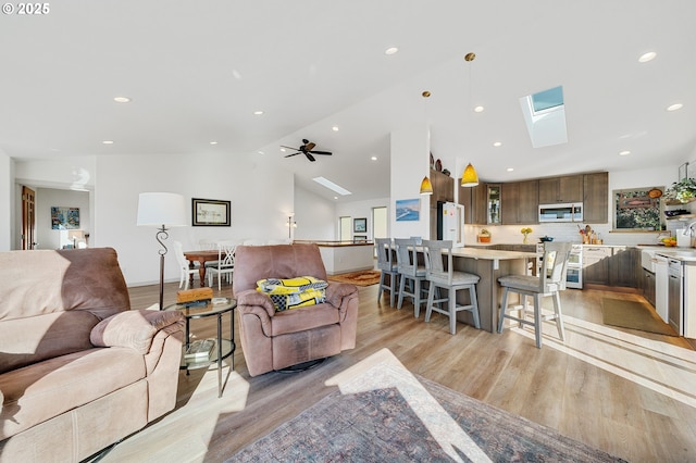 9065 8th St, Bay City, OR 97107 - living area with a skylight, light wood finished floors, lofted ceiling, recessed lighting, and ceiling fan