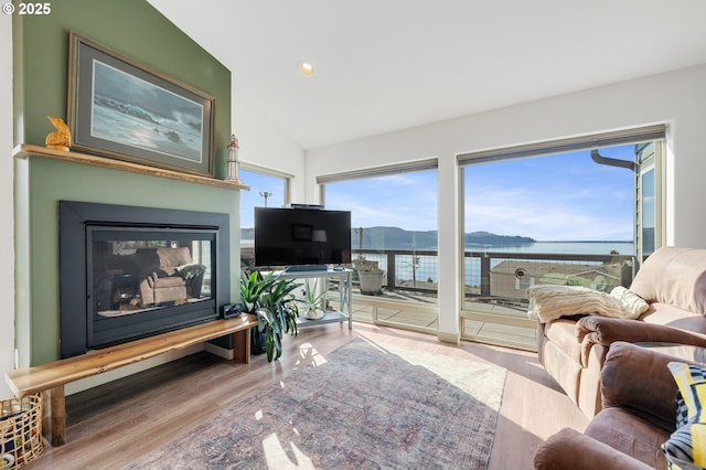 9065 8th St, Bay City, OR 97107 - living area featuring recessed lighting, wood finished floors, a glass covered fireplace, and vaulted ceiling