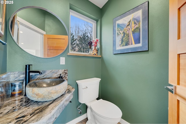 9065 8th St, Bay City, OR 97107 - bathroom with a sink, toilet, and baseboards