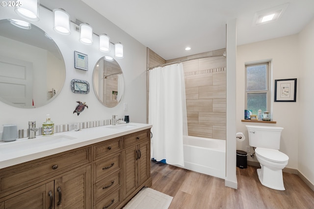 9065 8th St, Bay City, OR 97107 - bathroom with toilet, wood finished floors, double vanity, shower / bath combo, and recessed lighting