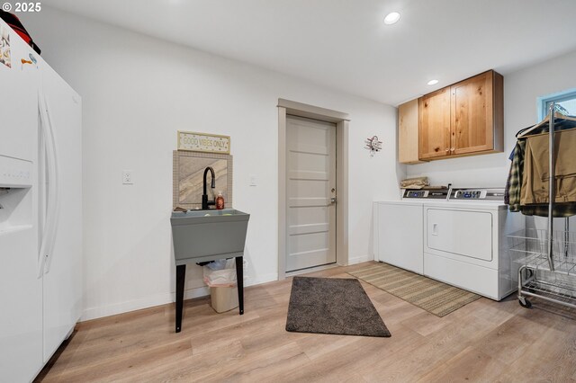 9065 8th St, Bay City, OR 97107 - laundry area featuring washer and dryer, cabinet space, light wood-style floors, recessed lighting, and baseboards