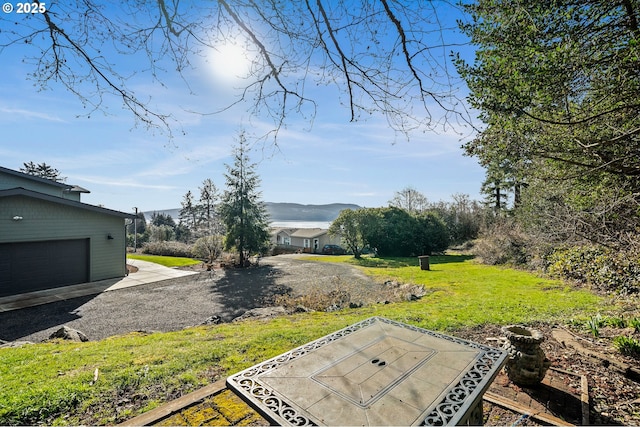 9065 8th St, Bay City, OR 97107 - view of grassy yard featuring a mountain view and driveway
