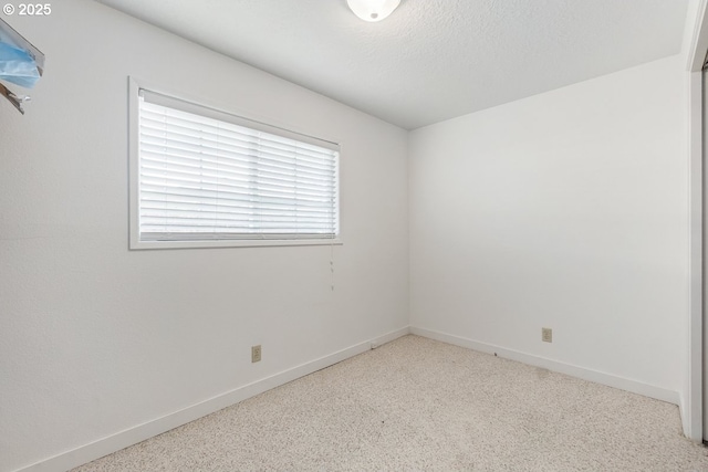 empty room featuring a textured ceiling