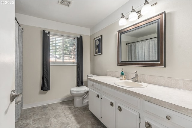 bathroom with vanity and toilet