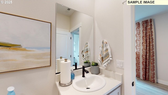 bathroom featuring vanity and wood finished floors