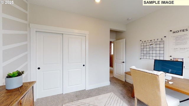 carpeted office space featuring baseboards