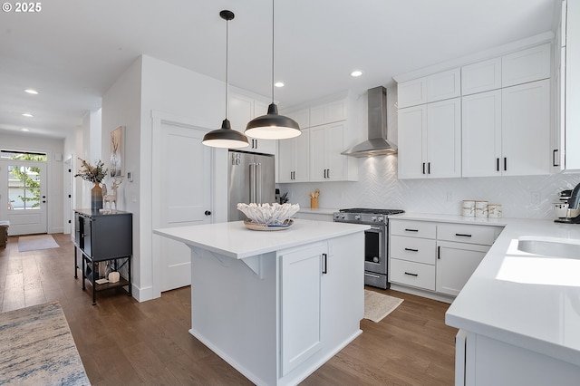 21773 SW Meadow Ter, Sherwood, OR 97140 - kitchen with high quality appliances, wall chimney range hood, dark wood finished floors, decorative backsplash, and light countertops